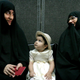 Iranian women wait to cast their votes in the second round of the Iranian presidential election in Tehran June 24, 2005.